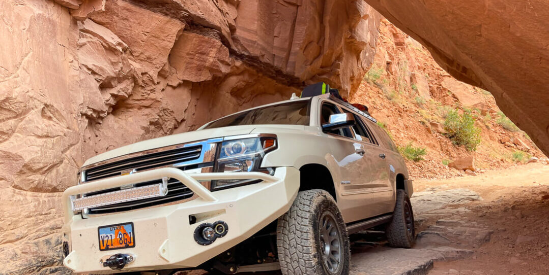 Chevy Solitude driving under boulder