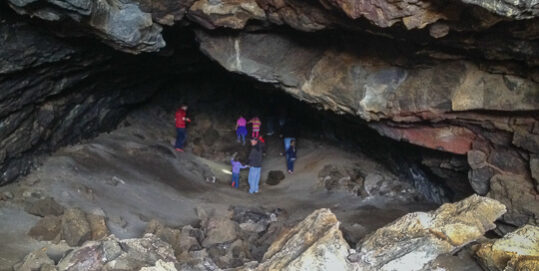 people in lava cave tunnel